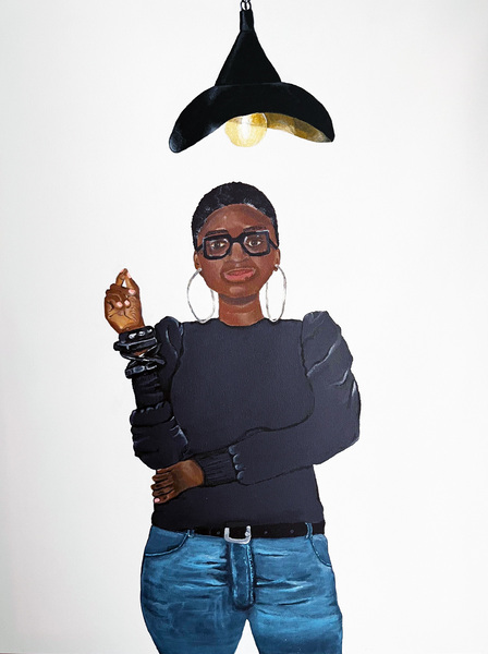 Self portrait of a woman with close cropped hair and hooped earrings, wearing a long sleeve black shirt, and black bracelets on her right arm, and jeans. Left arm is across her belly. Thick, square glasses on her face. Standing under a black lamp shaped l