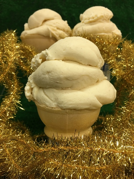 Scoop of ice cream on a cone with gold garland decoration
